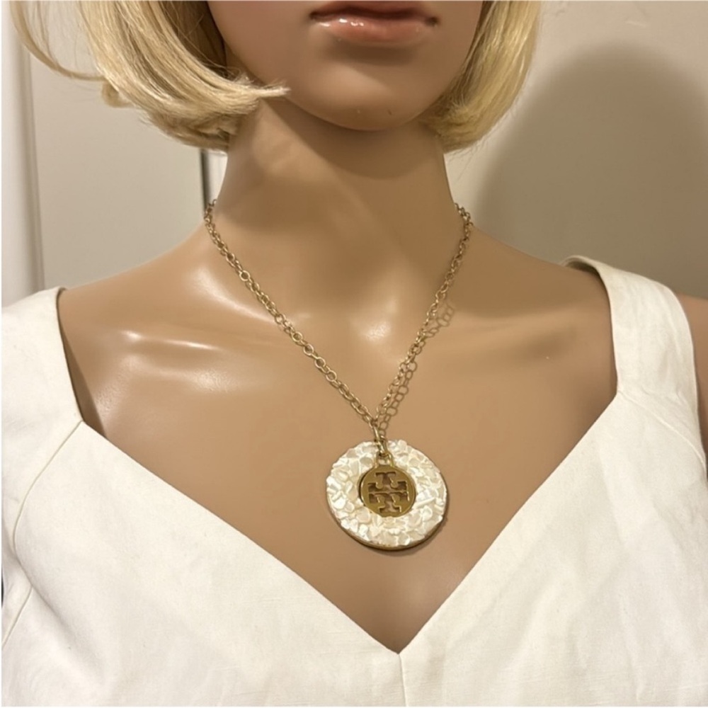 Goldtone and white Pendant with
Tory Burch Round Charm